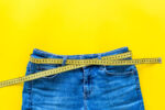 Weight,Loss,Concept,With,Pants,And,Measuring,Tape,On,Yellow